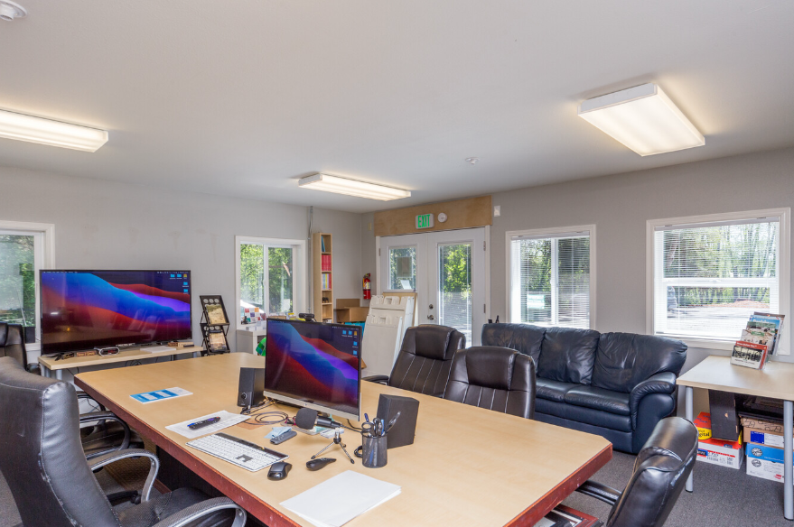 Shared desk with laptops and plants